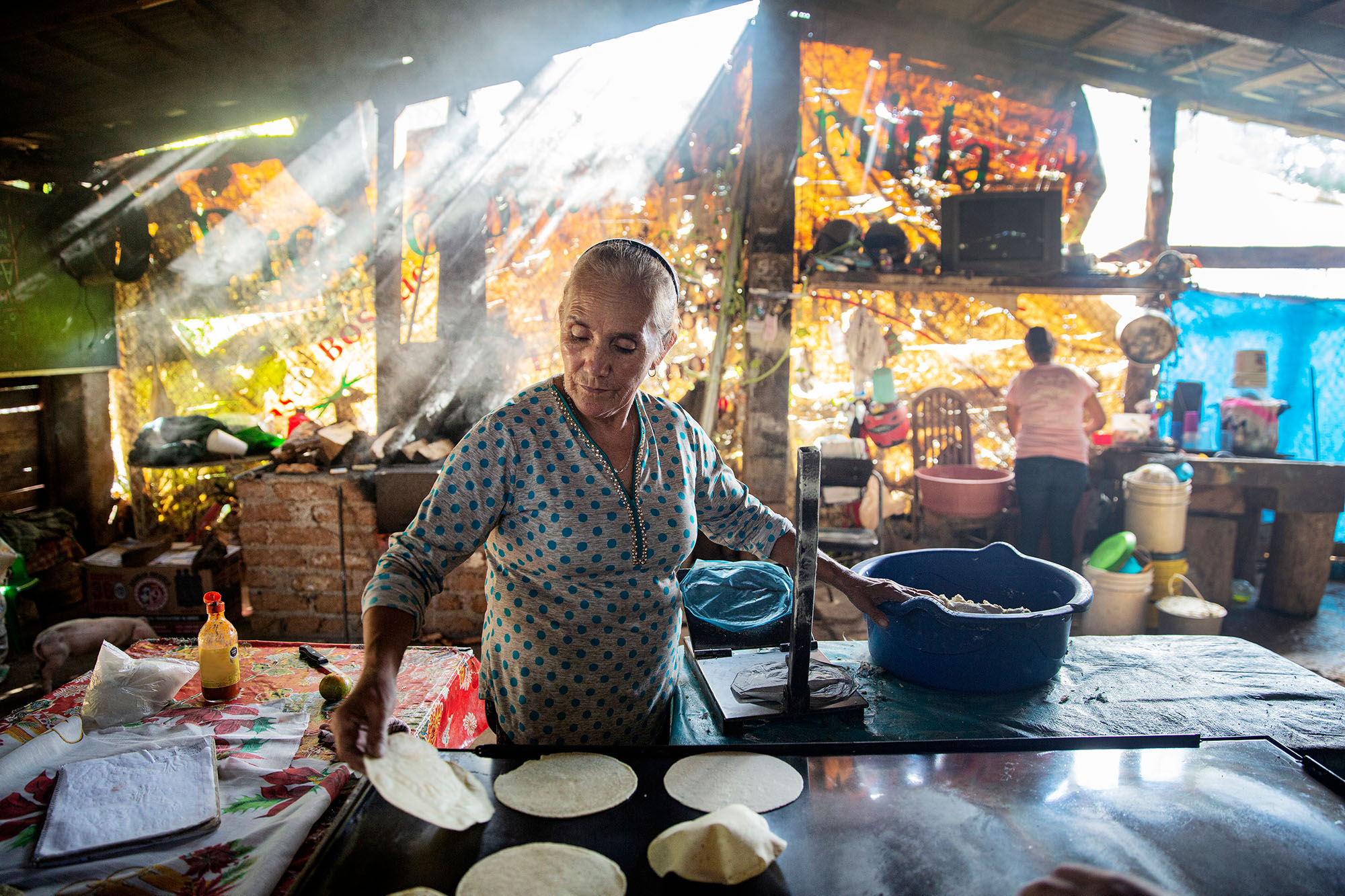 Woman making traditional tortillas