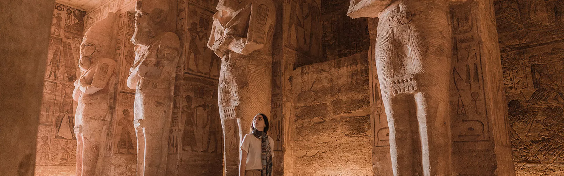 woman walking through egyptian temple