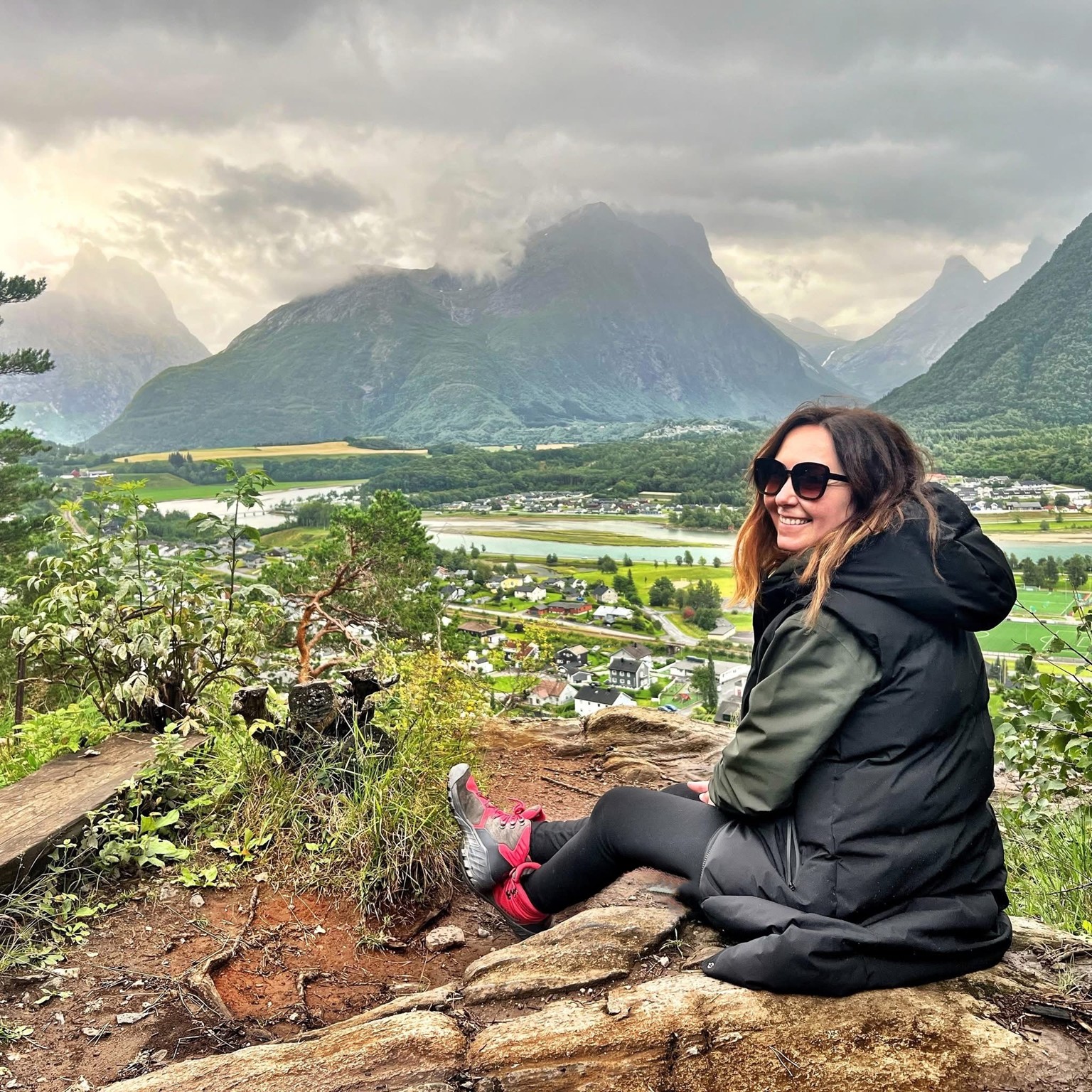 person standing in front of a valley with mountains in the back