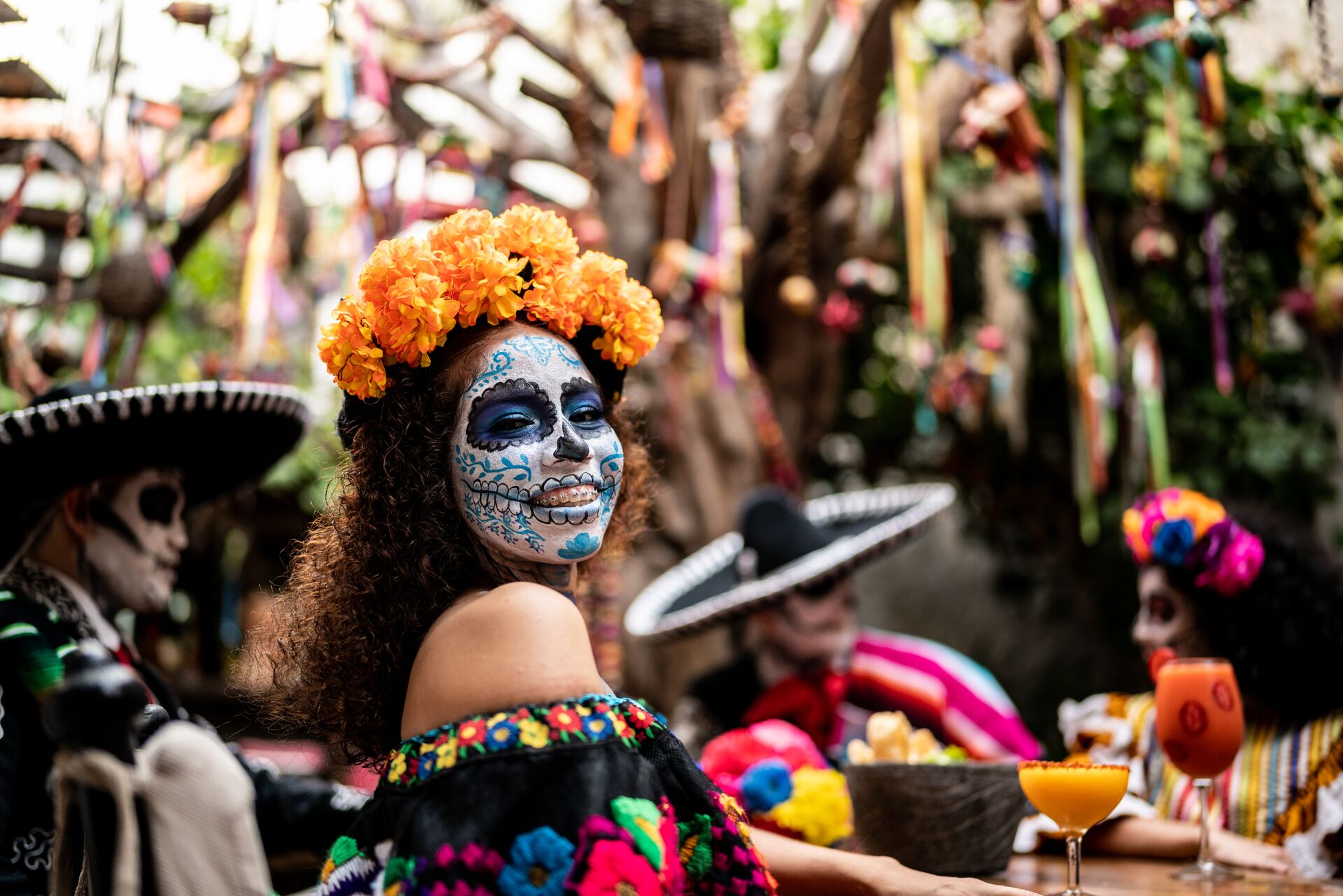 people in day of the dead makeup and outfits