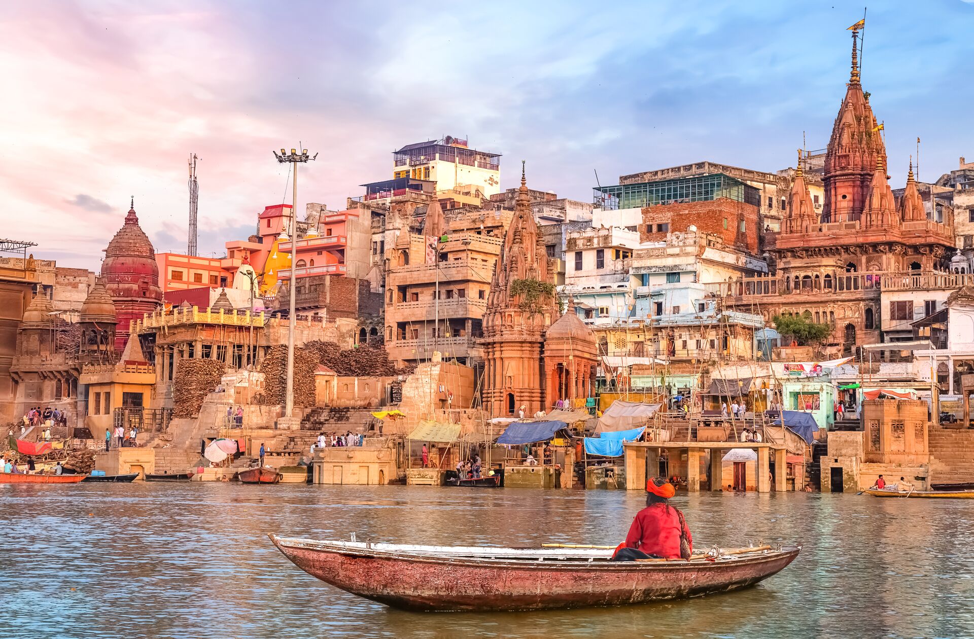 Hindu Sadhu Sitting On A Boat Overlooking The City