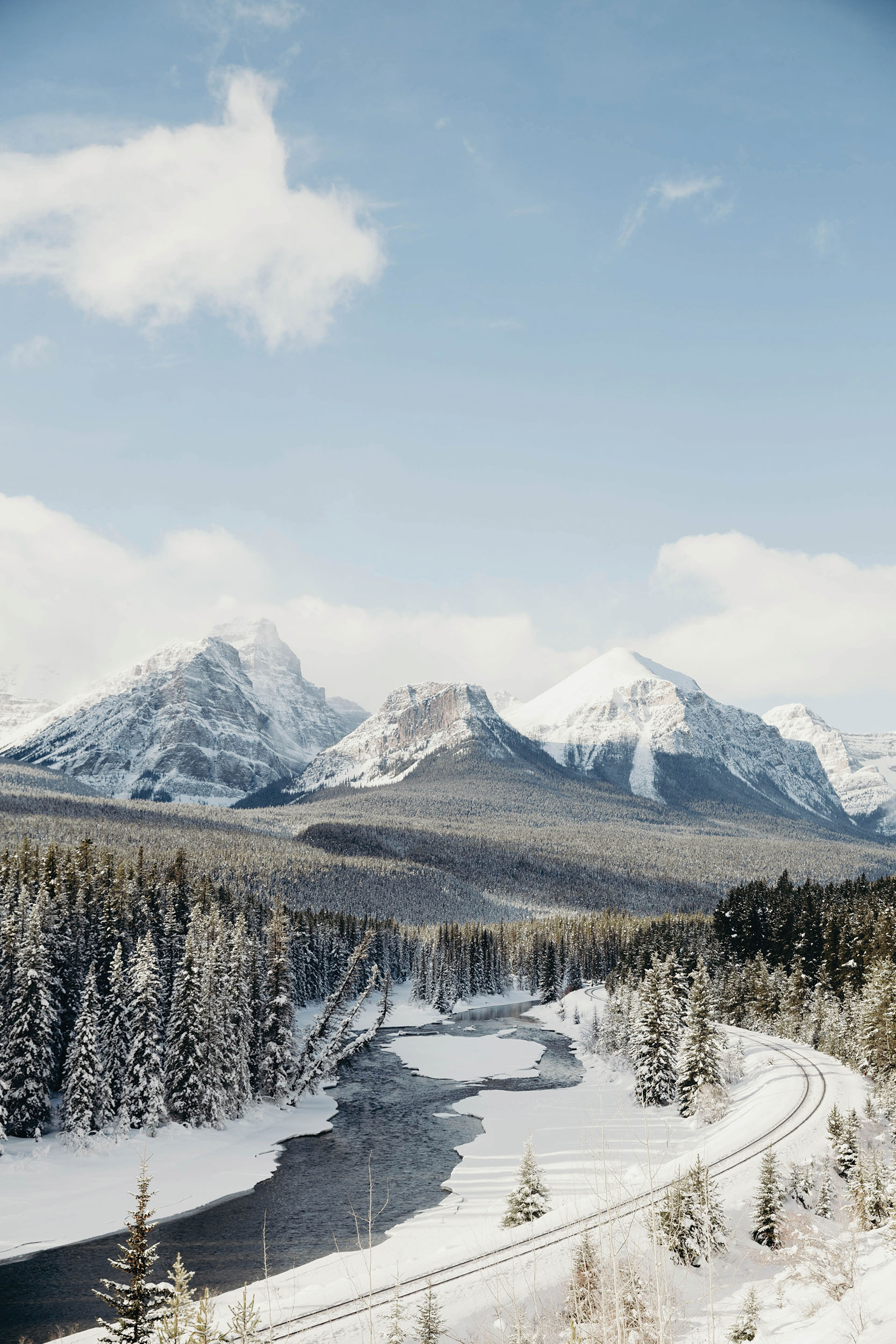snowy mountain with a rail going in front of it