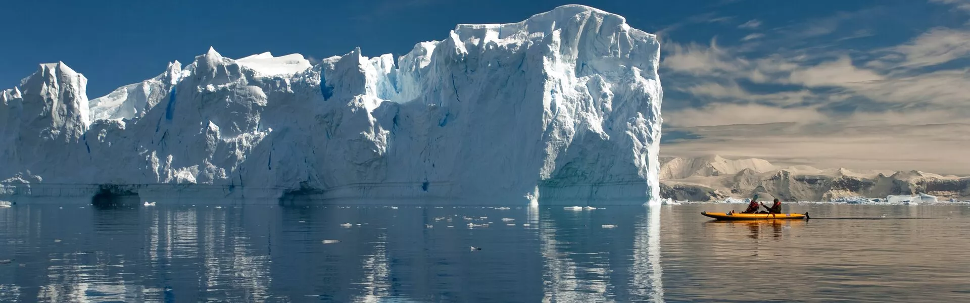 sea kayaking with a large ice formation