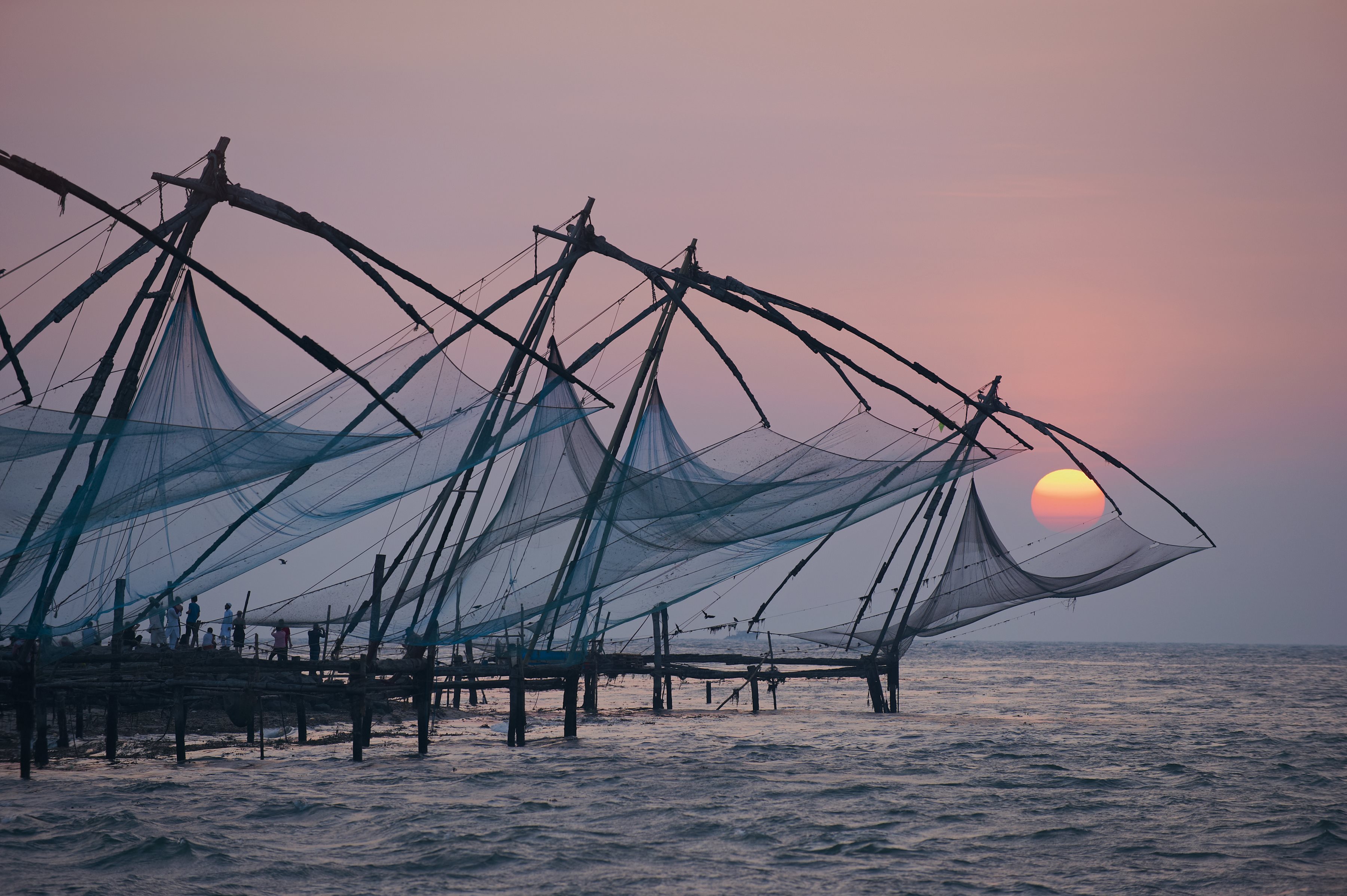 A group of fishing nets sitting on top of a body of water