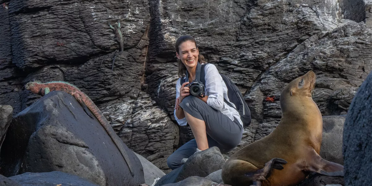 Woman With Sea Lion and Marine Iguana