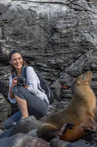 Woman With Sea Lion and Marine Iguana