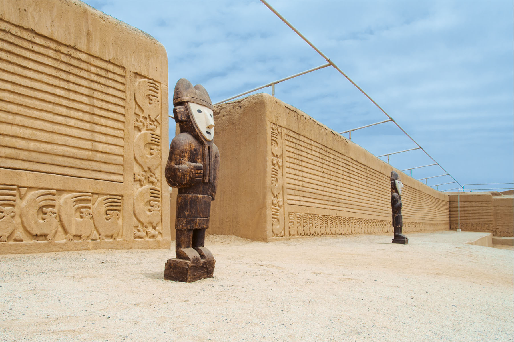 Ancient statues in front of an archaelogical site.