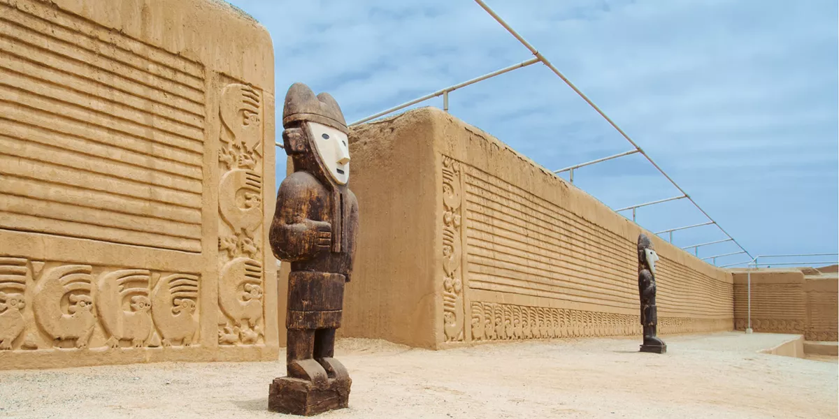Ancient statues in front of an archaelogical site.