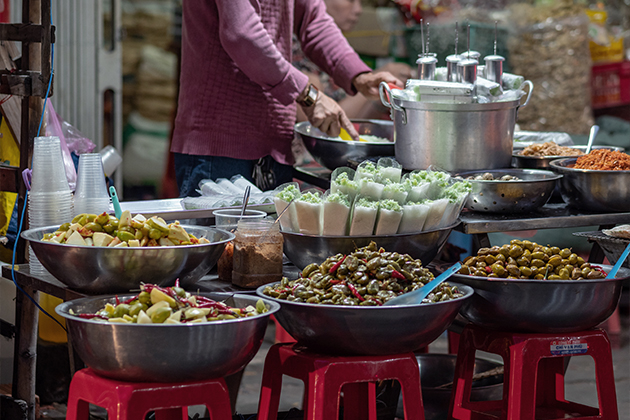 A woman standing in front of a table filled with food