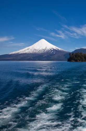 Looking out the back of a boat crossing a lake