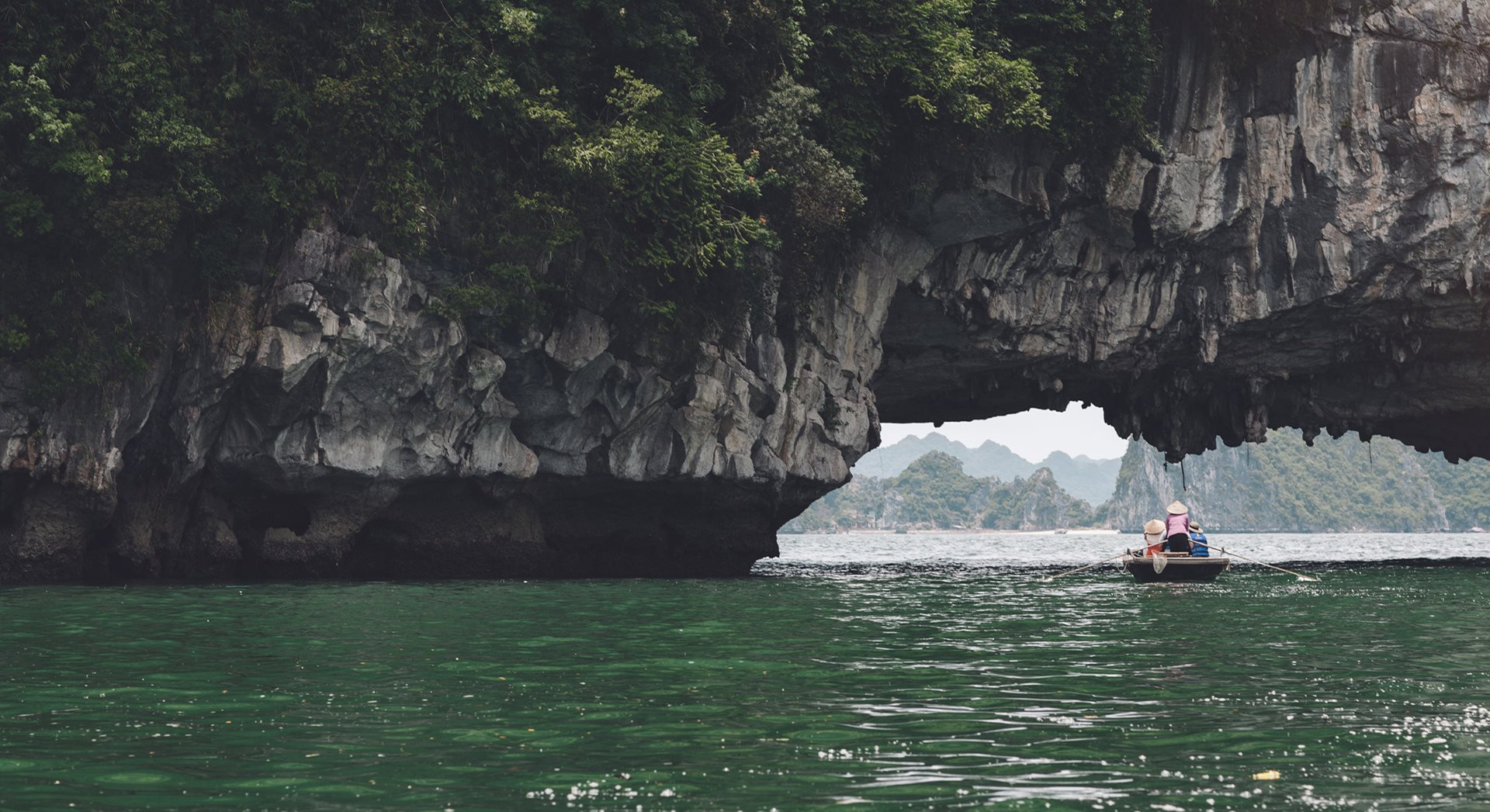 A person in a small boat in Ha Long bay