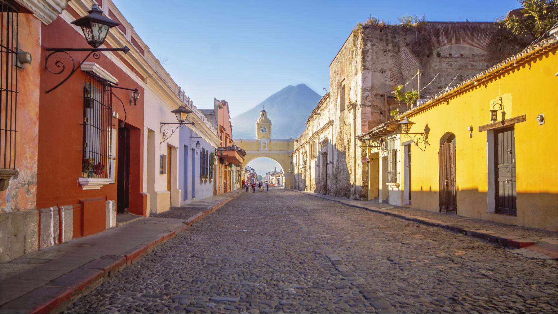 view looking down a colourful street with an arch over the end of the street