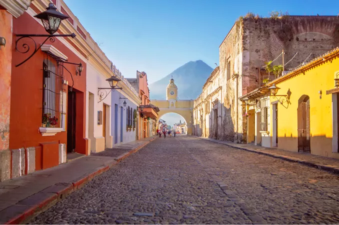 view looking down a colourful street with an arch over the end of the street