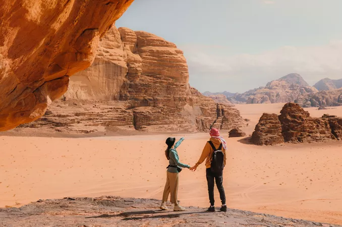 Young Woman And Man Traveler Contemplating The Scenic Landscape