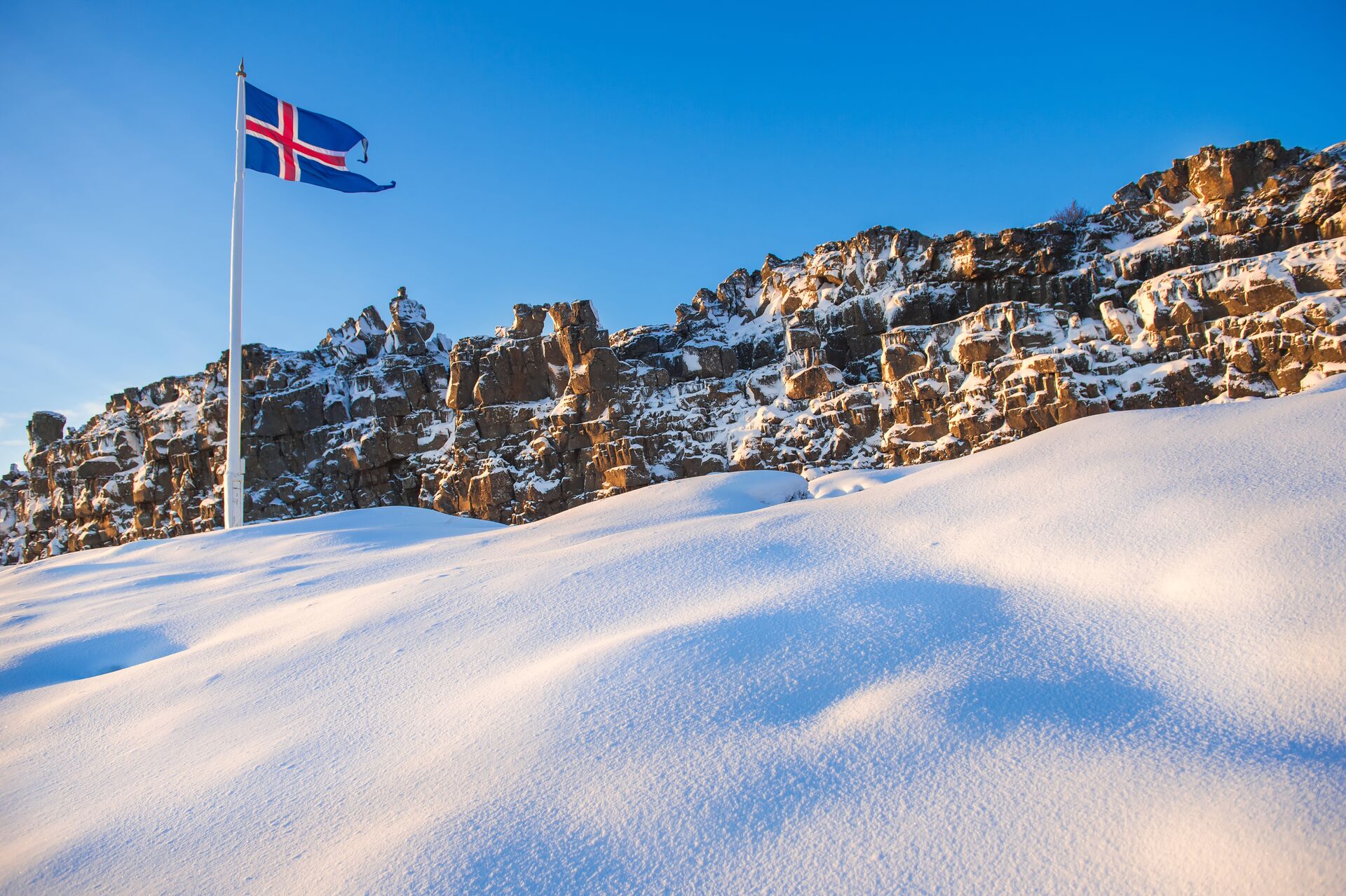 Icelandic flag flying in wintery Thingvellir National Park