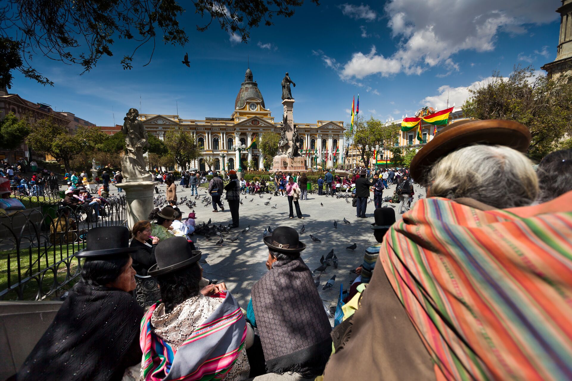 People moving around a plaza in traditional clothing