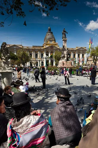 People moving around a plaza in traditional clothing