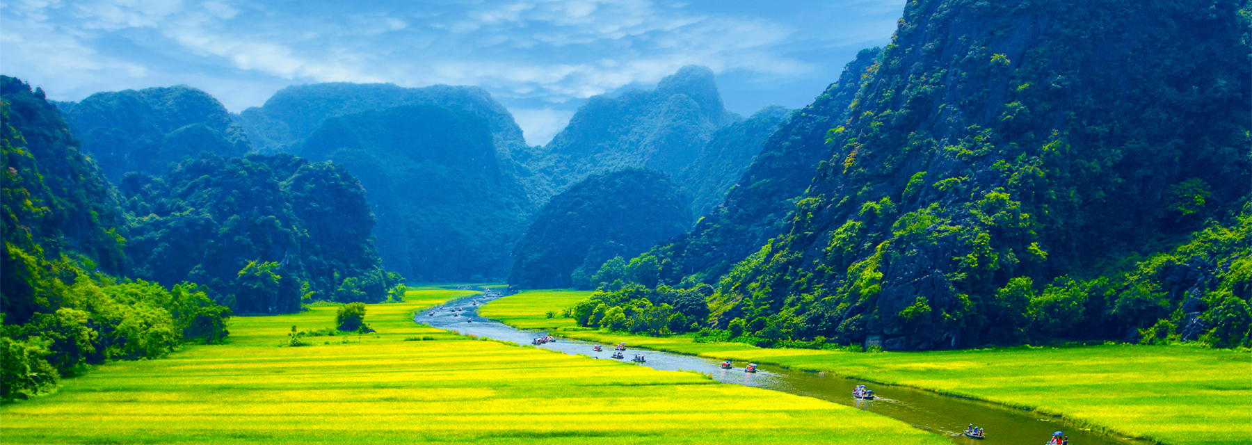 A river running through a lush green valley