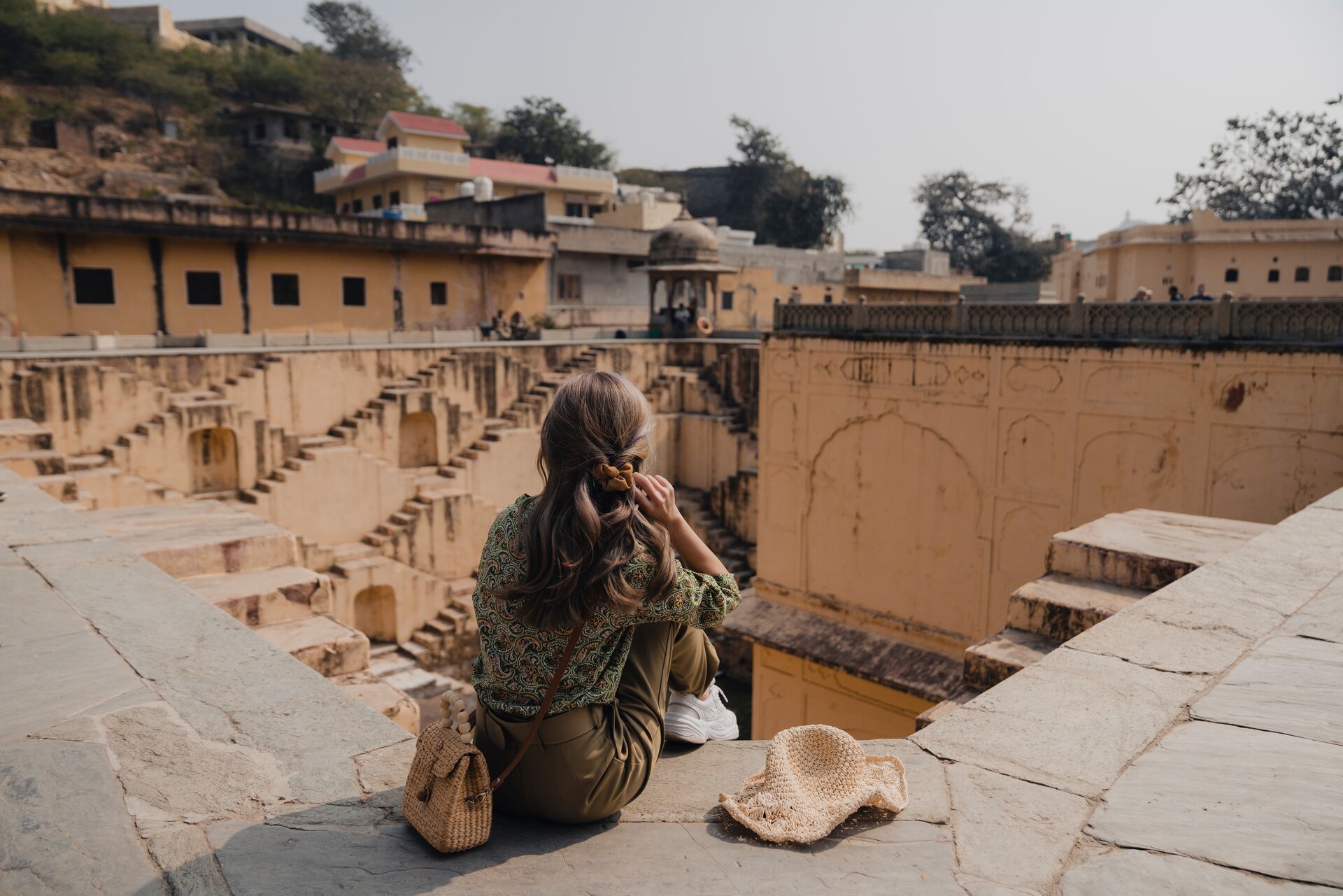 Woman sitting In Front Of Stepwell