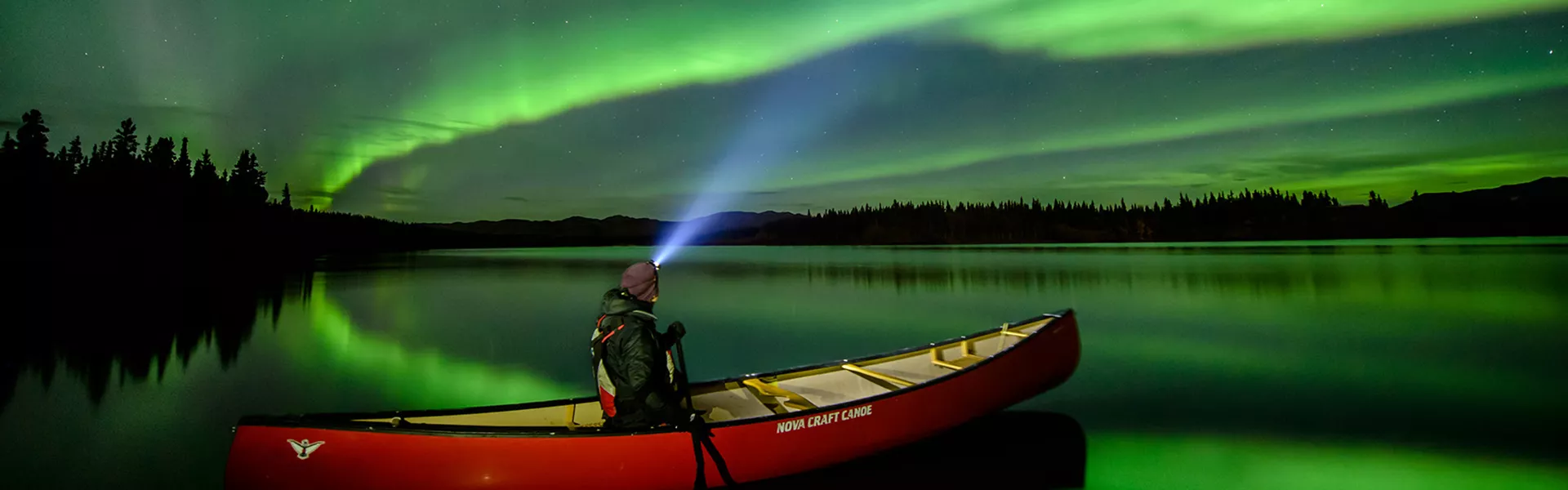 Person in a Canoe under the northern lights