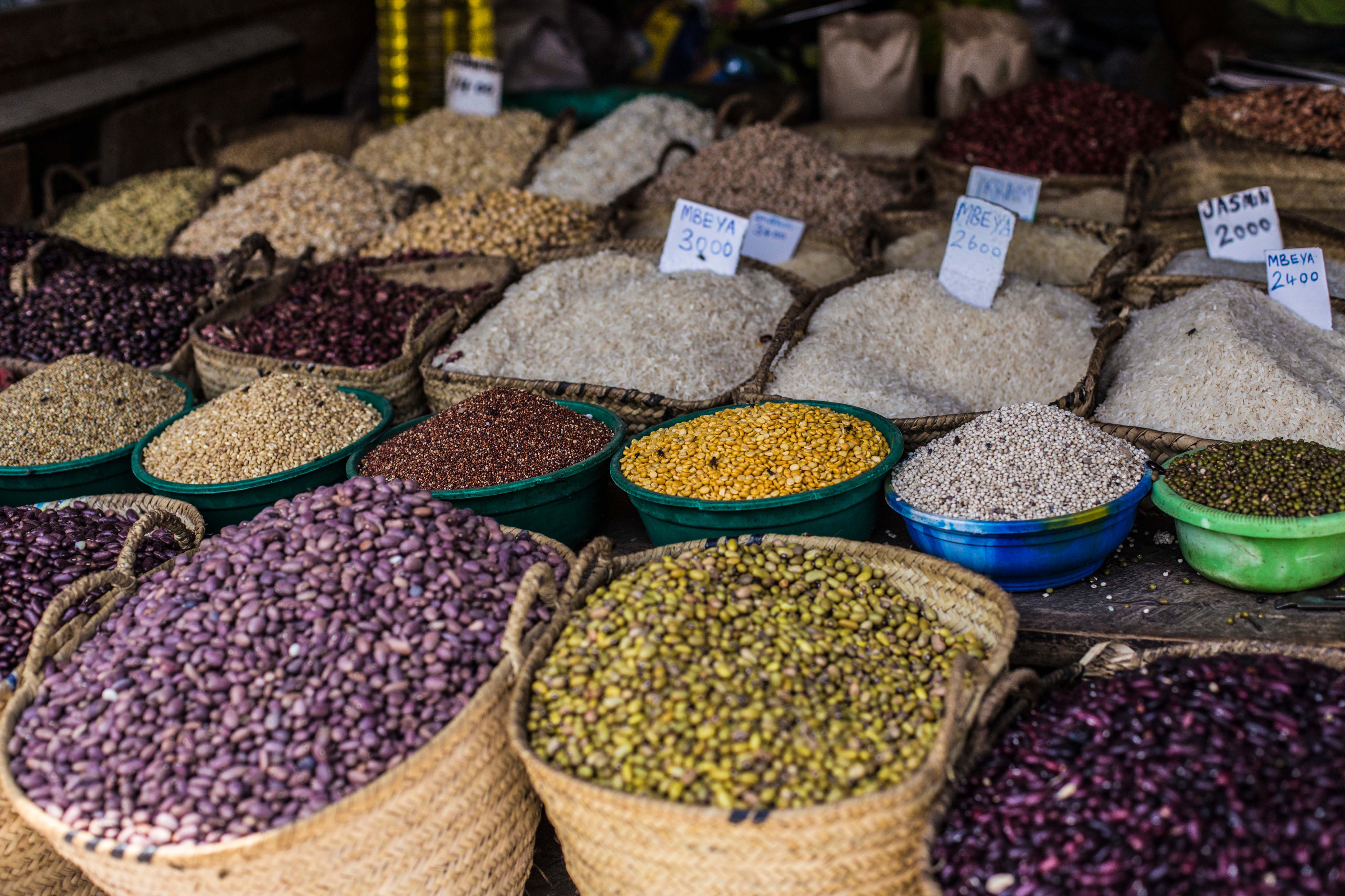 A bunch of baskets filled with different types of beans