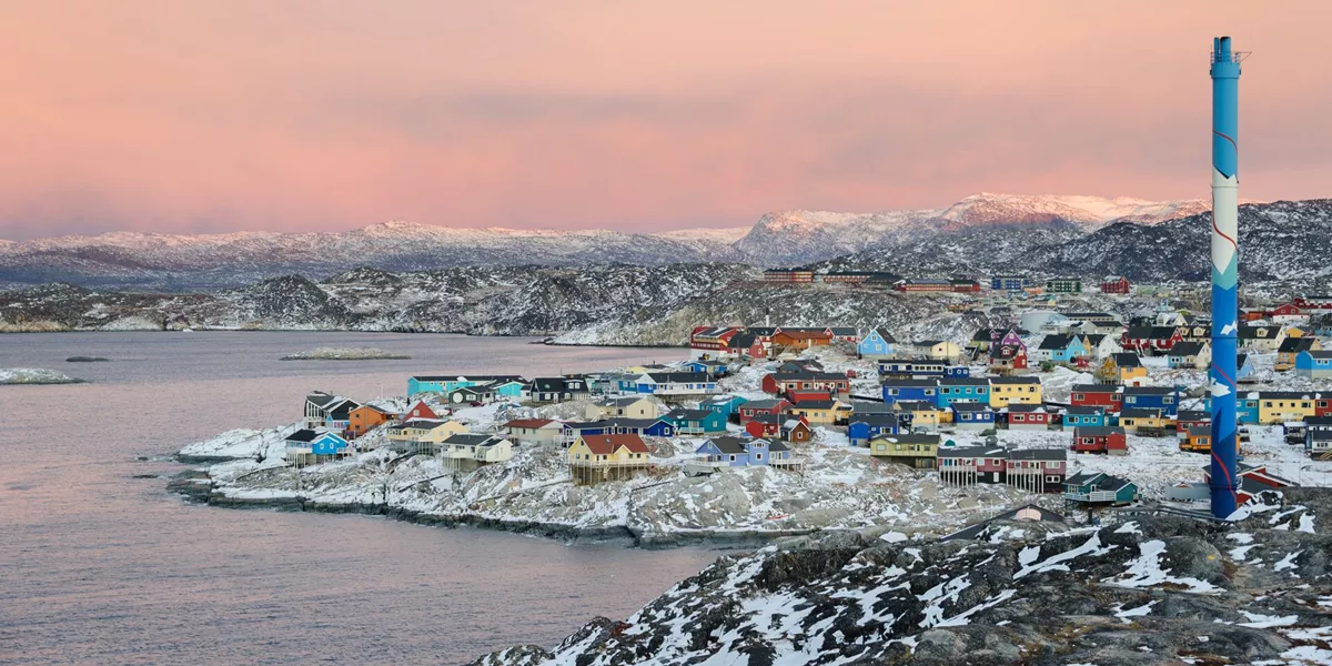 Town on the coast in arctic region at sunset