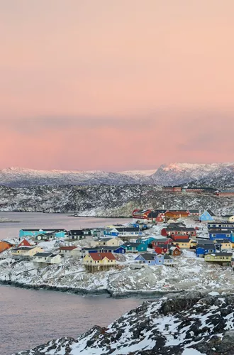 Town on the coast in arctic region at sunset