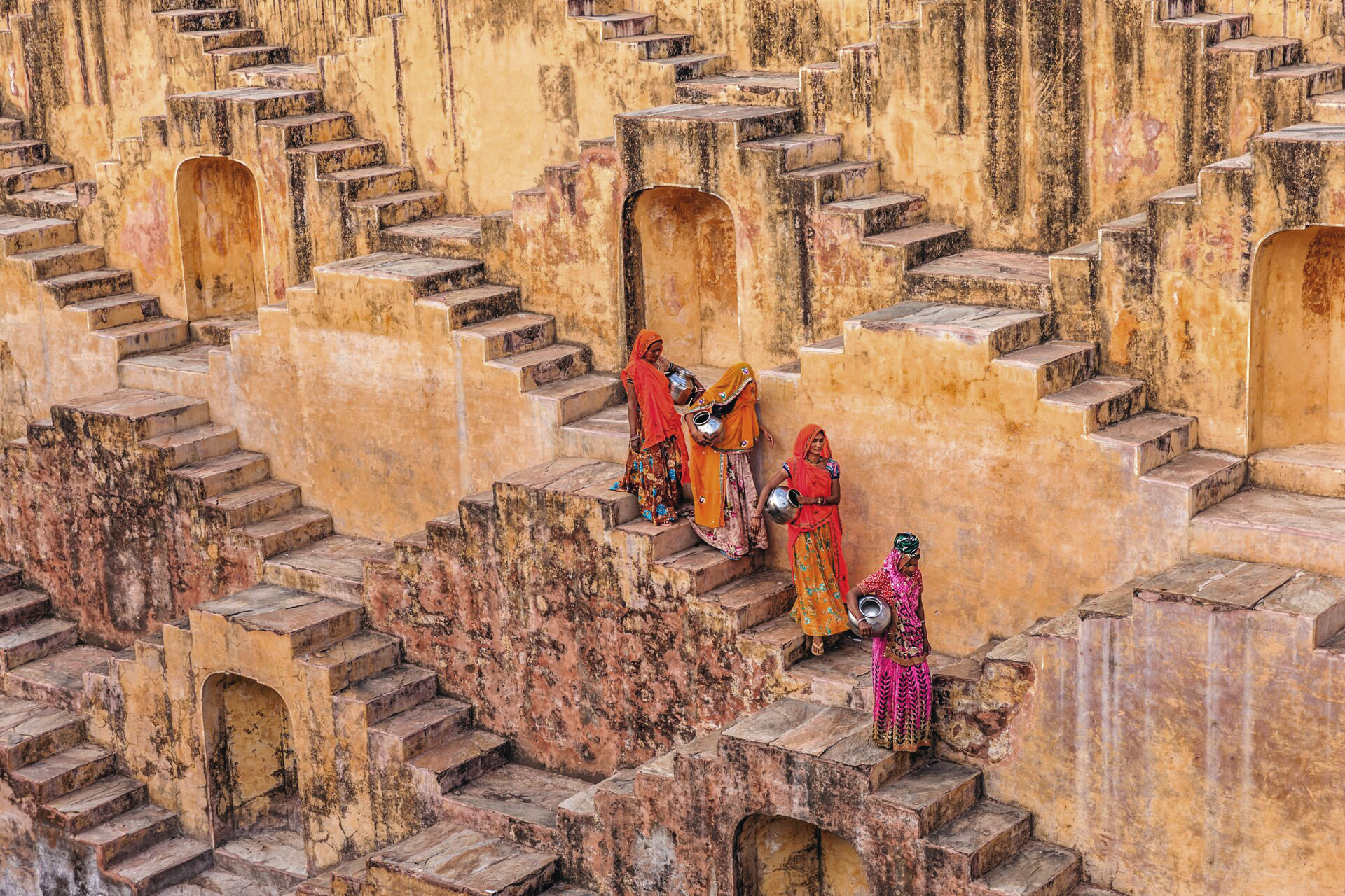 A group of people in costumes standing on top of stone steps