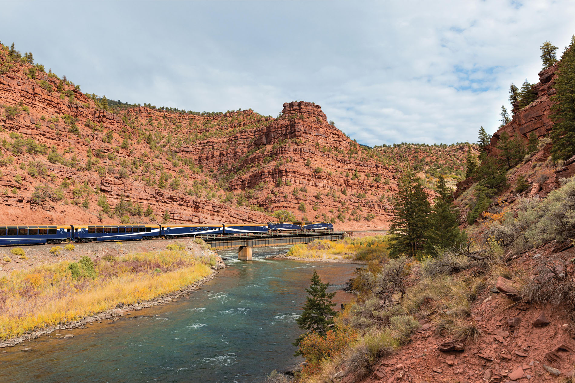 Train going through a red canyon gorge
