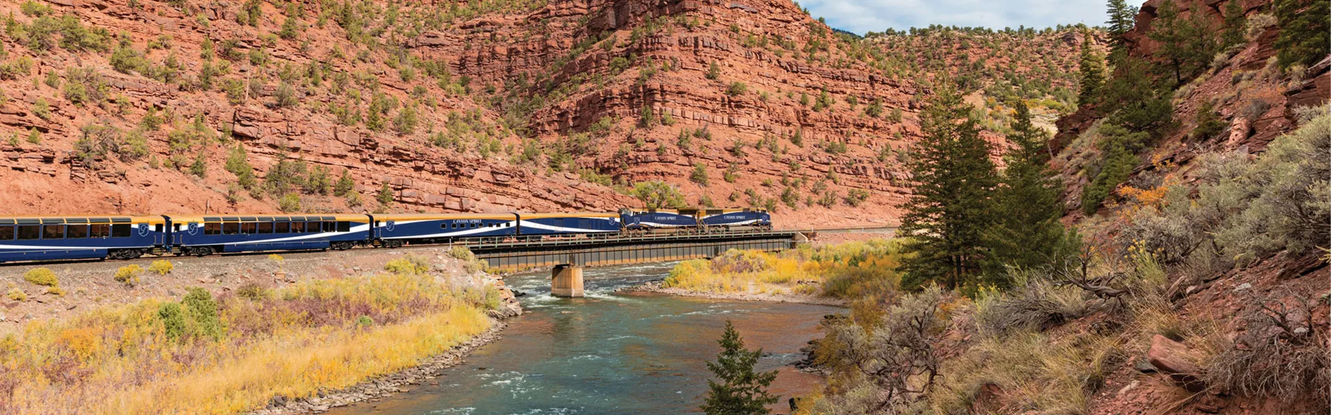 Train going through a red canyon gorge