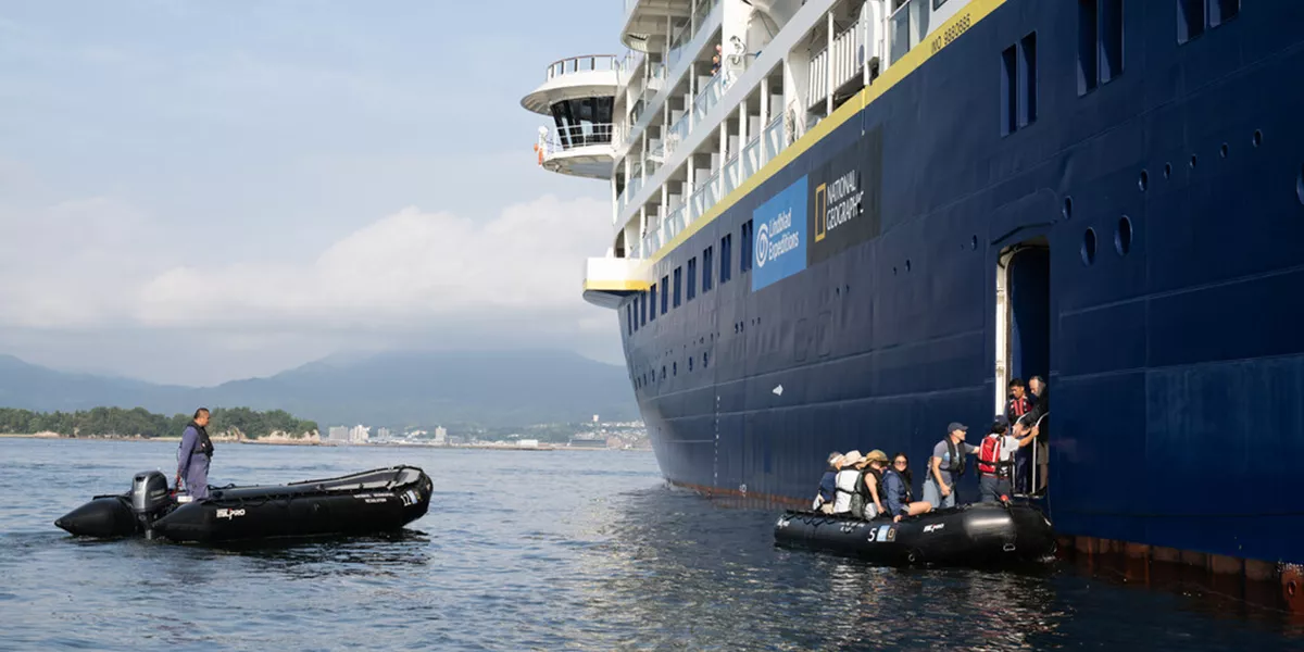 people boarding a zodiac