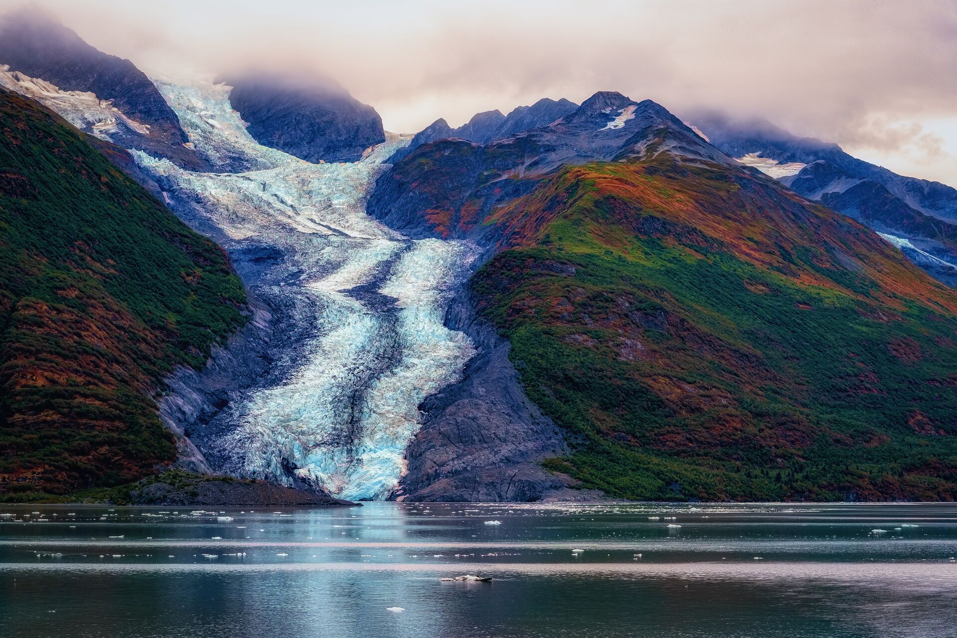 Glacier down a mountain leading into the sea