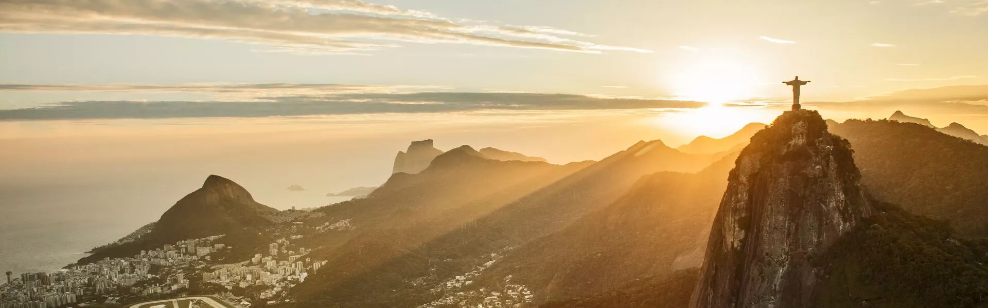 view of a city at sunset from the mountains