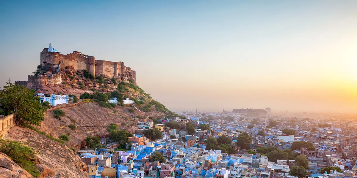 fort overlooking a city full of blue buildings