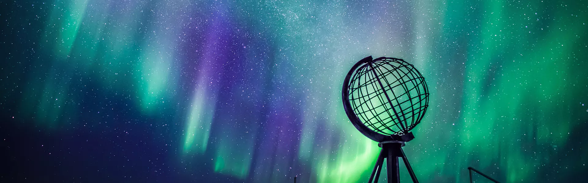 Northern Lights behind globe statue