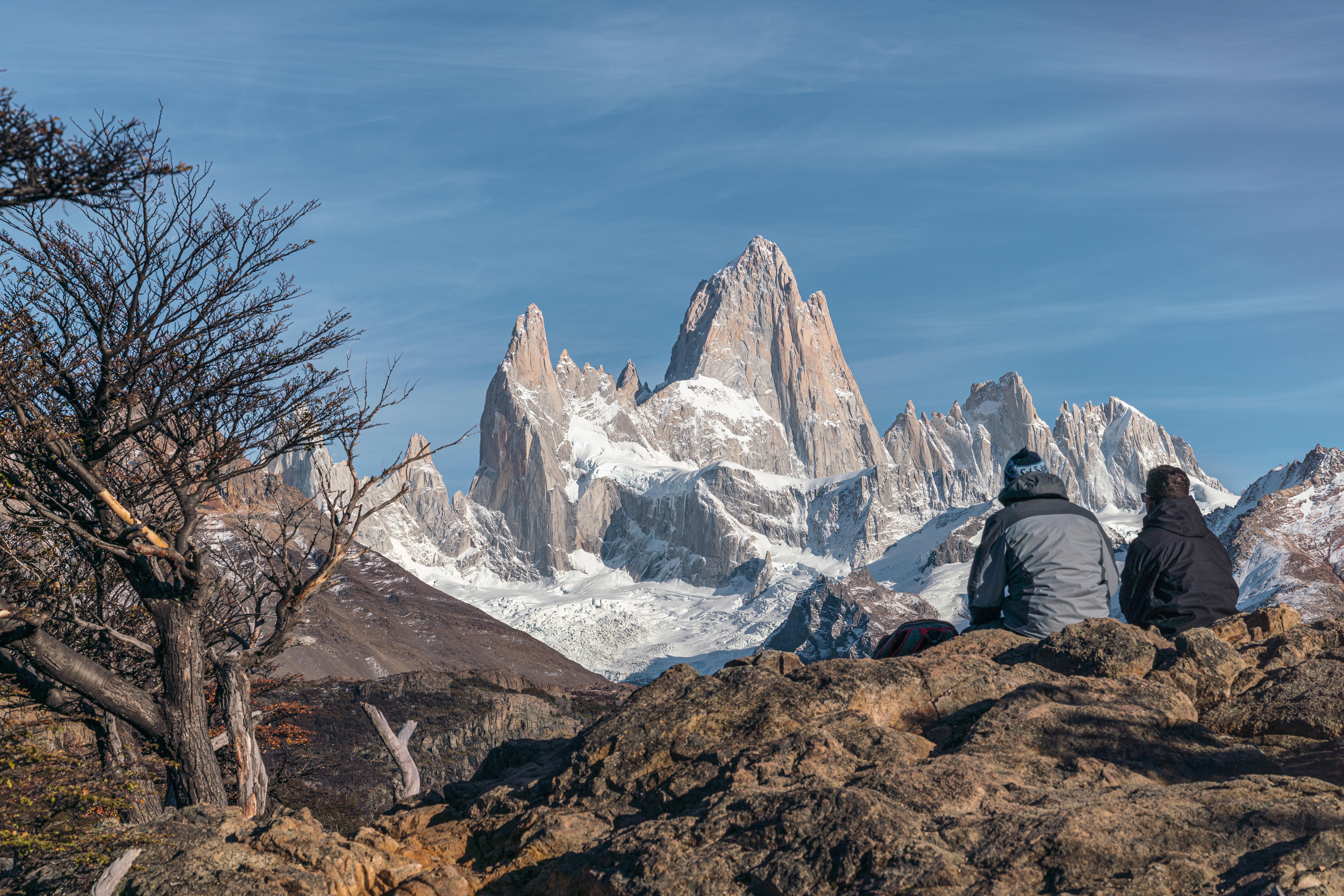 A couple of people looking at the mountains