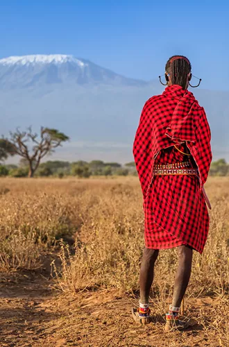 Warriors From Maasai Tribe Looking At Mount Kilimanjaro, Kenya, Africa