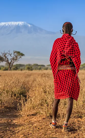 Warriors From Maasai Tribe Looking At Mount Kilimanjaro, Kenya, Africa