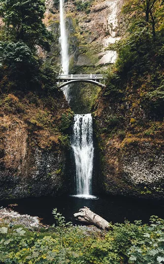 bridge across a waterfall